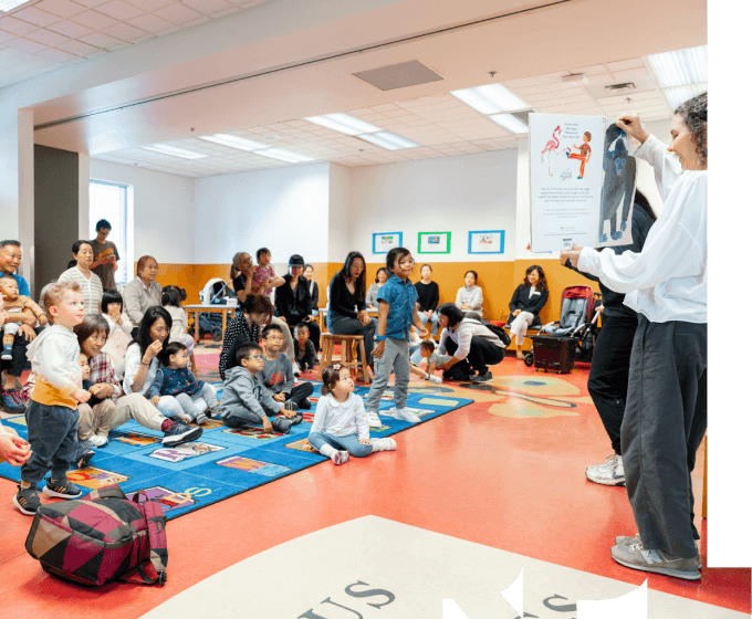 Families and children at a library story time reading event