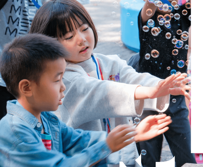 Children playing with a bubble machine
